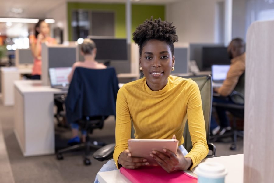 Portrait of smiling african american young businesswoman sitting Portrait of smiling african american young businesswoman sitting